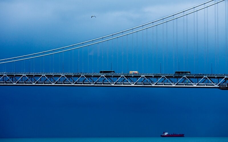 Suspension bridge over blue water