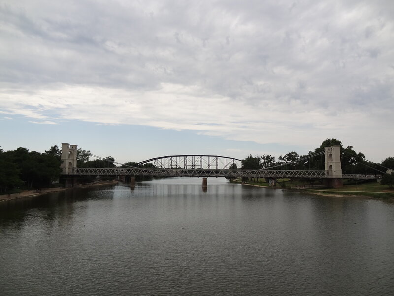 Suspension Bridge over River — Gray, Overcast