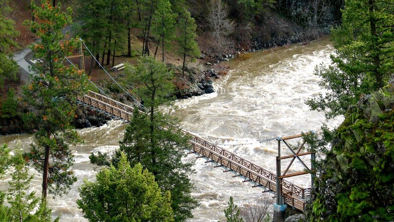 Suspension bridge over rushing river