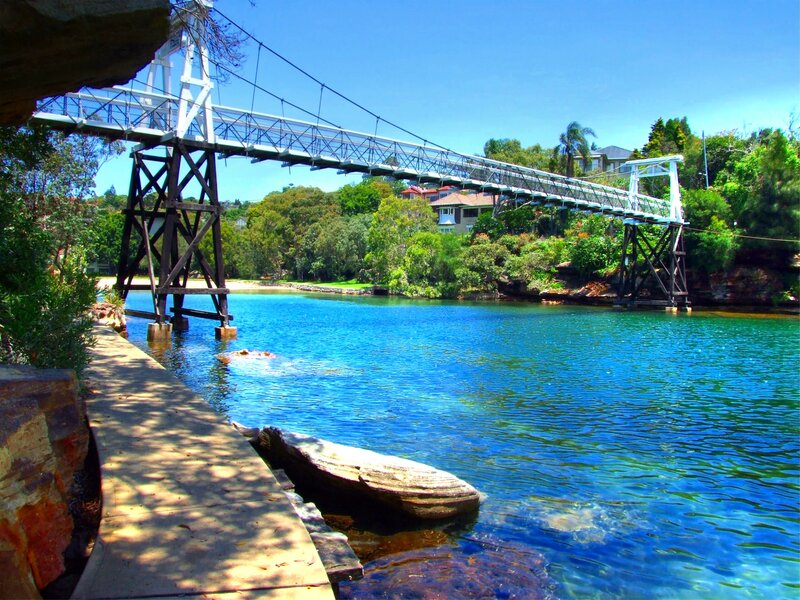 Suspension Bridge over Water — Blue, Serene, Afternoon