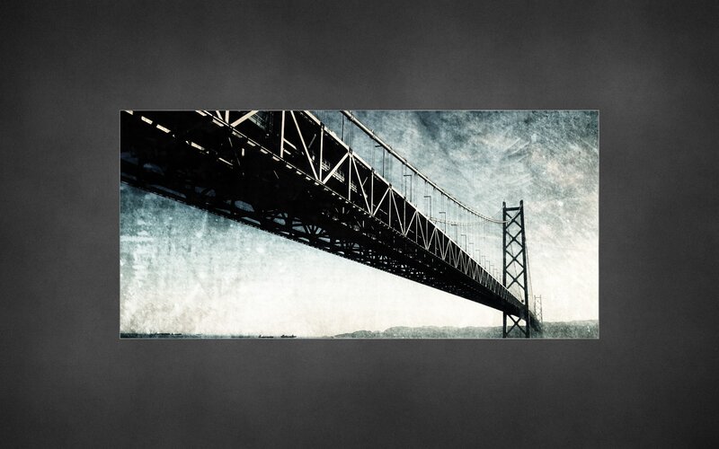 suspension bridge under dramatic sky