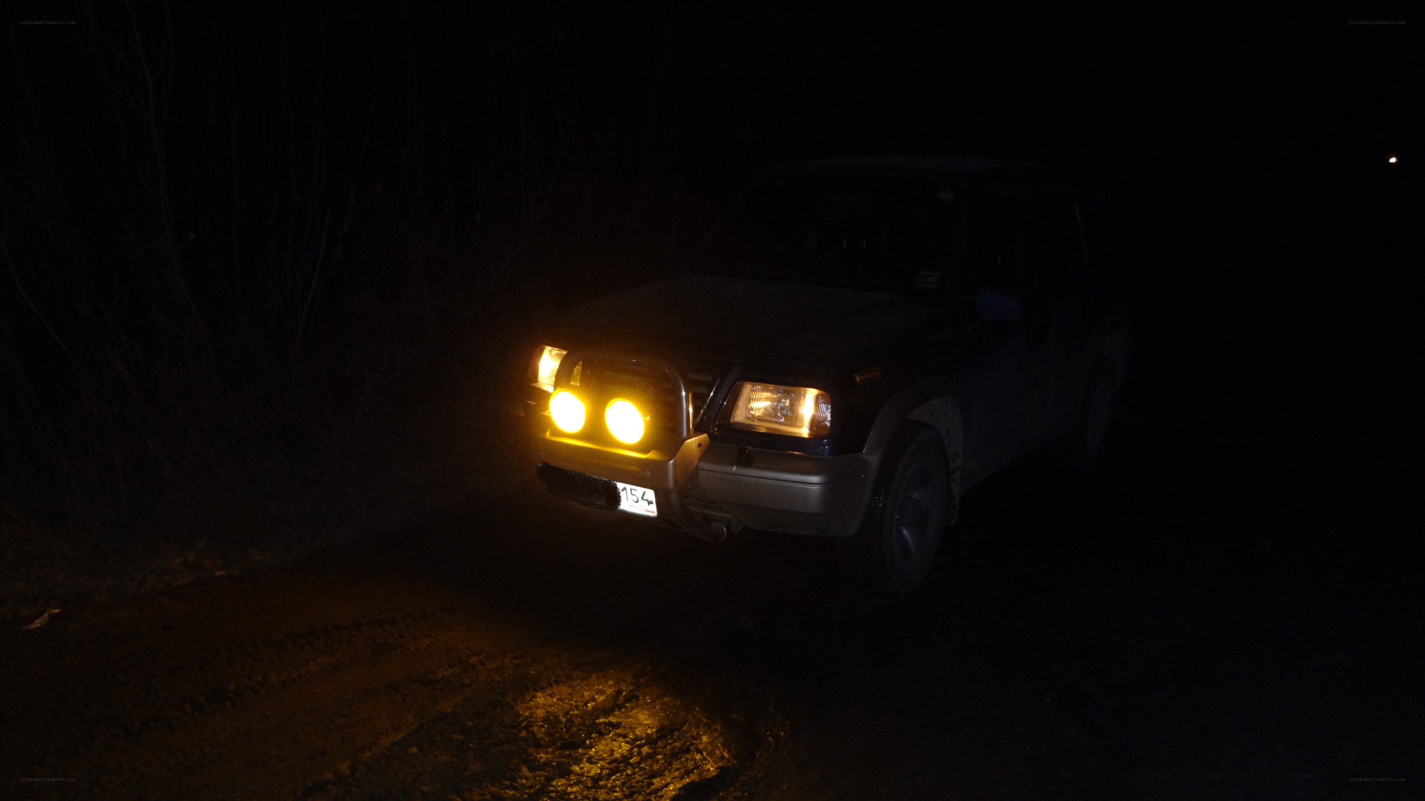 SUV at night with headlights on