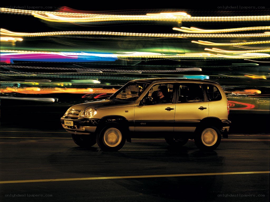 SUV at night with light trails