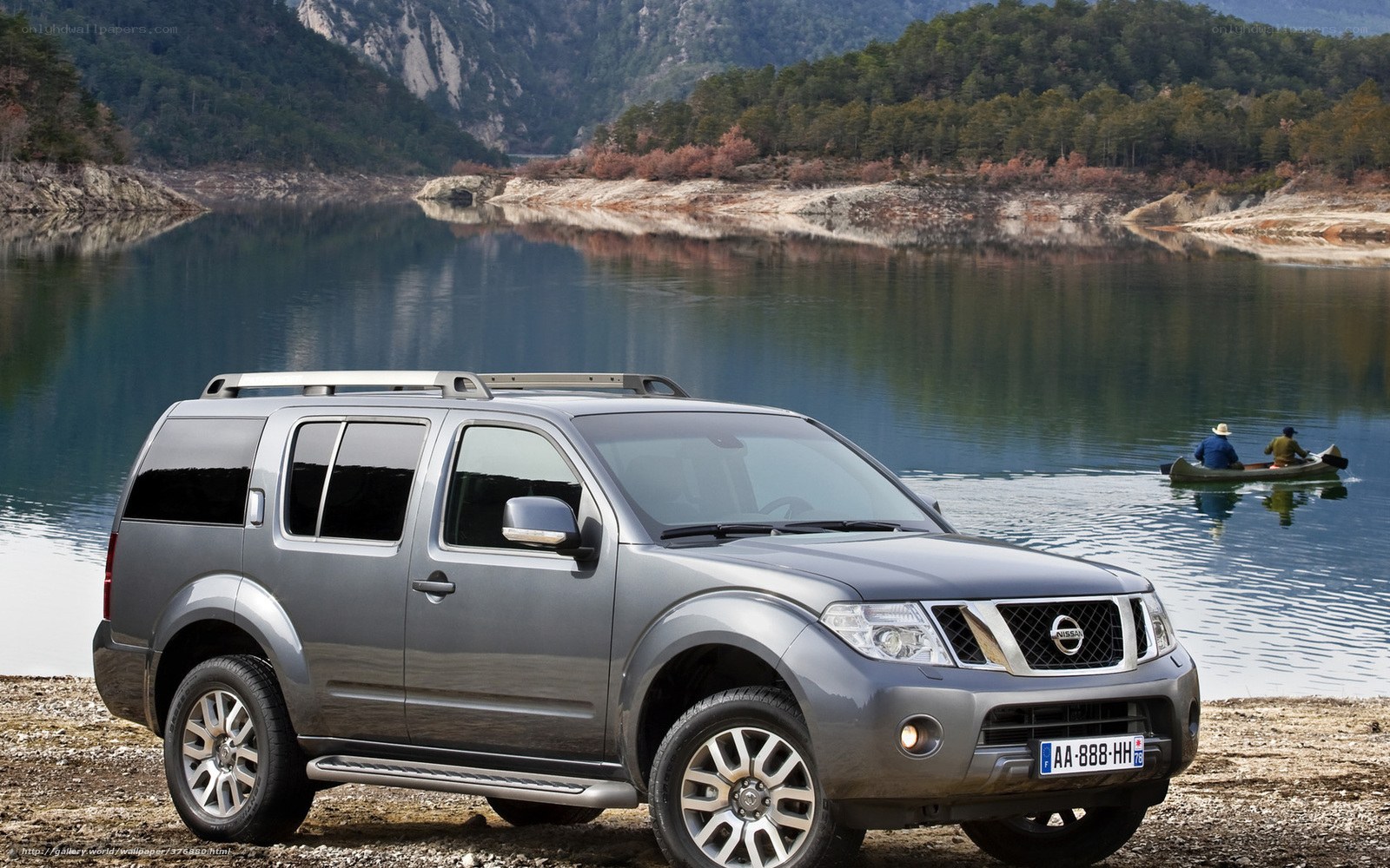 SUV by a lake with canoe