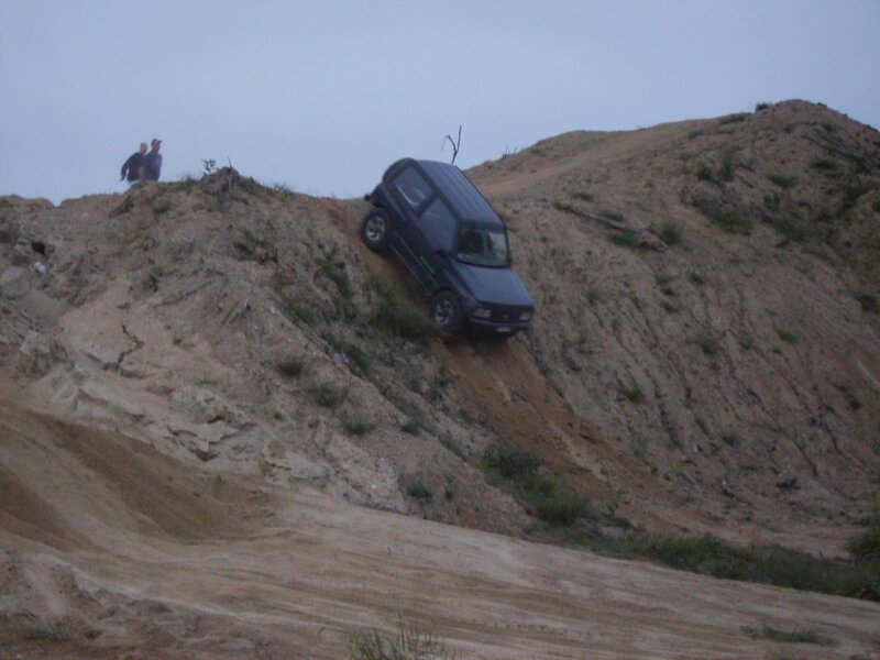 SUV climbing a steep dirt hill