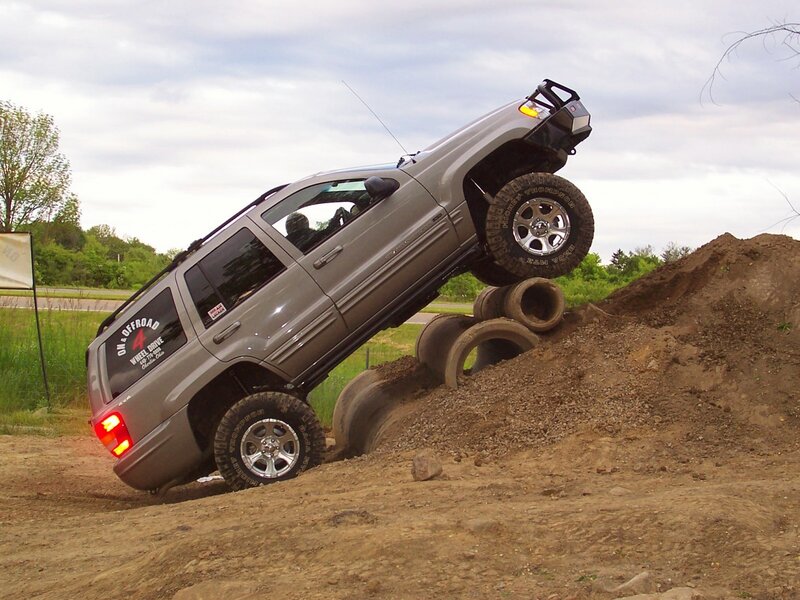 SUV climbing over tires