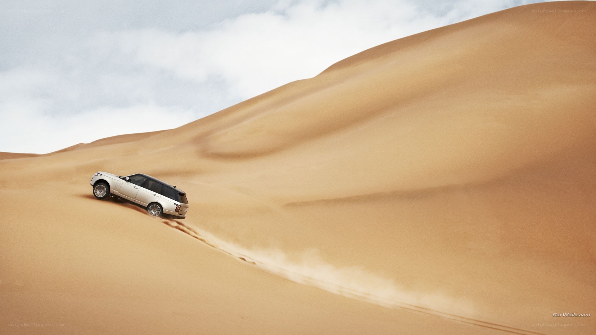 SUV climbing sand dune
