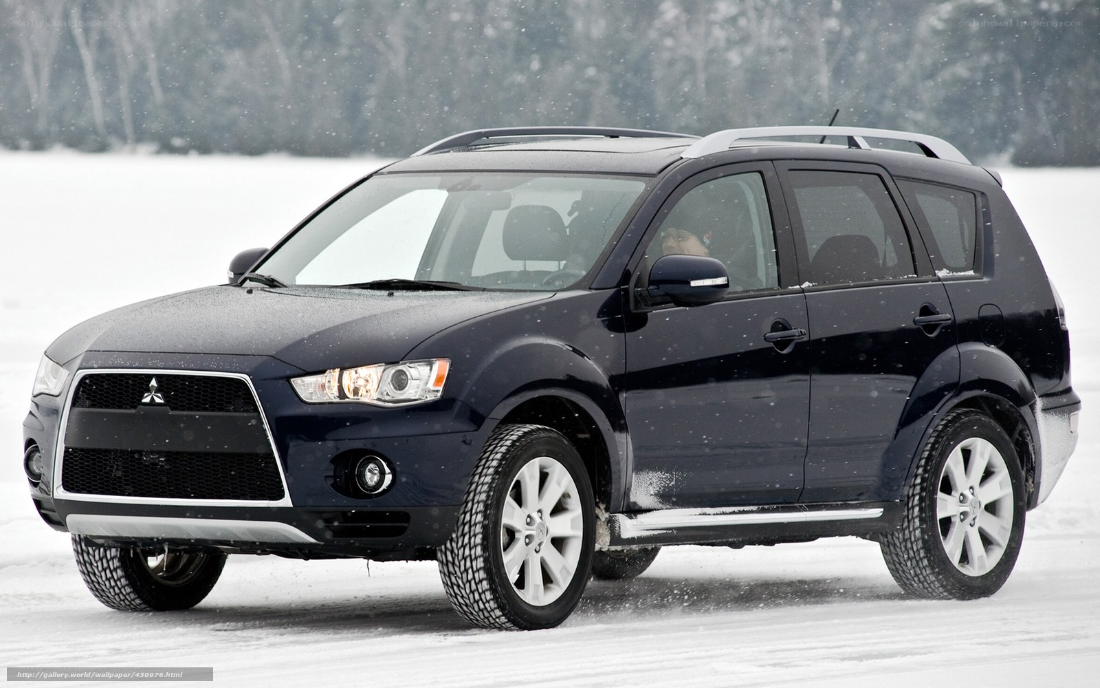 SUV driving in snowy landscape