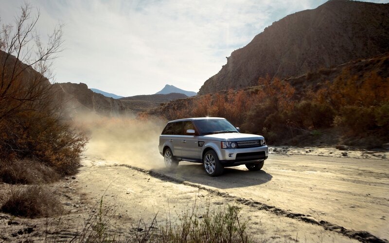 SUV driving on a dusty trail