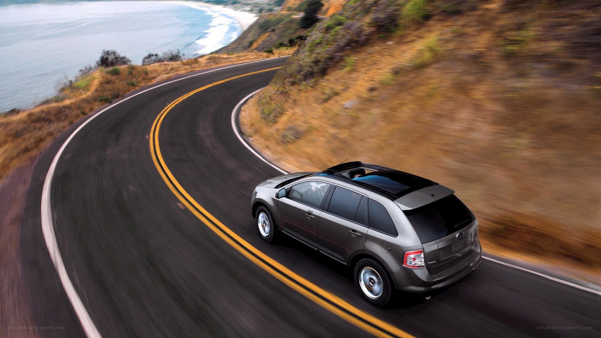 SUV driving on coastal road