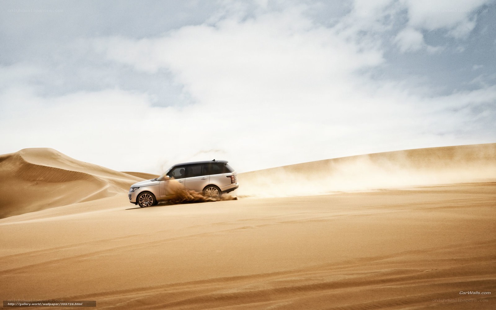 SUV driving on desert dunes