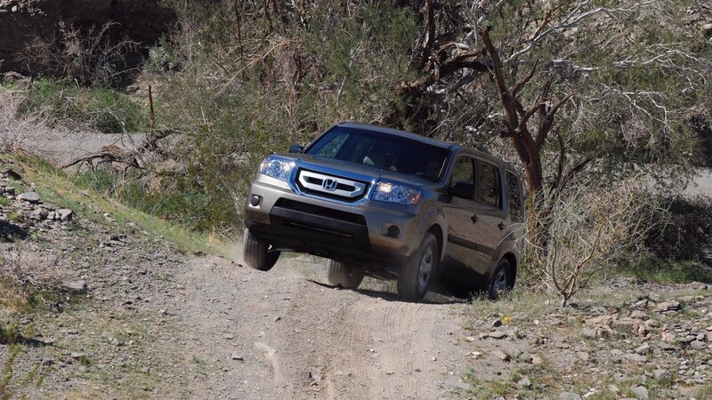 SUV driving on dirt path