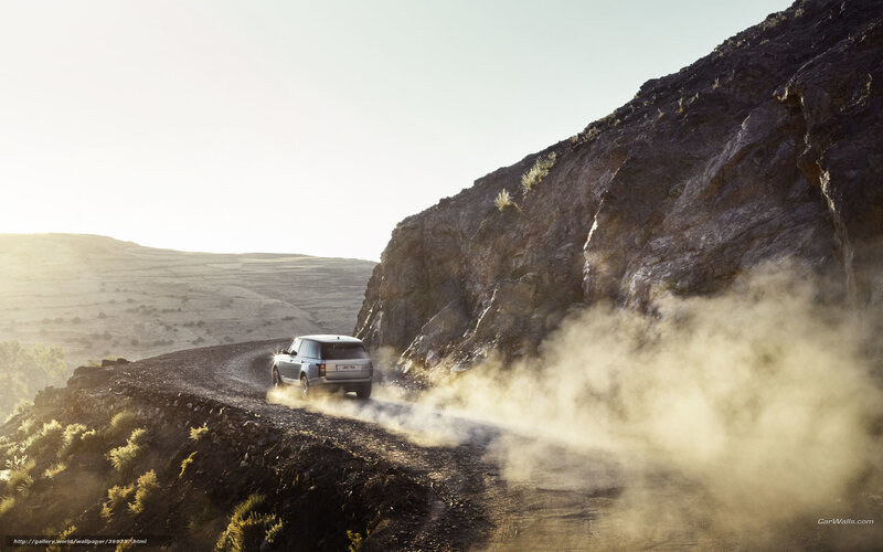 SUV driving on dusty mountain road