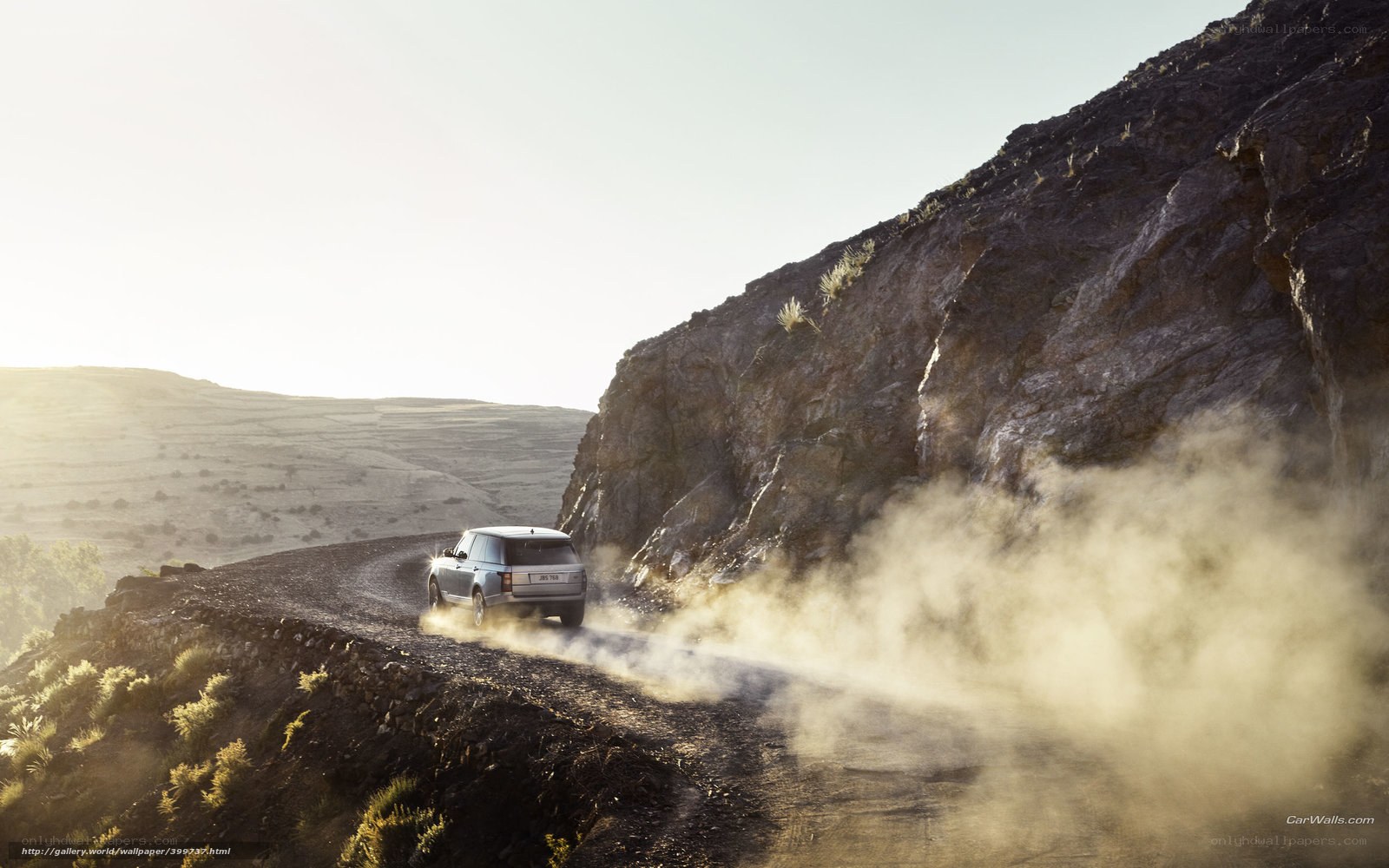 SUV driving on dusty mountain road
