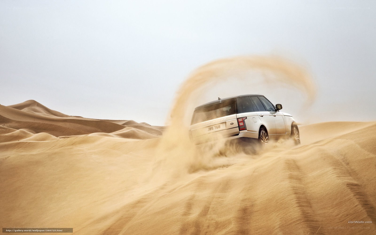SUV driving on sand dunes