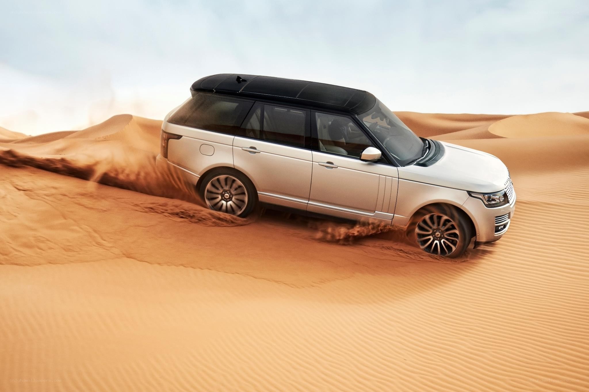 SUV driving on sand dunes