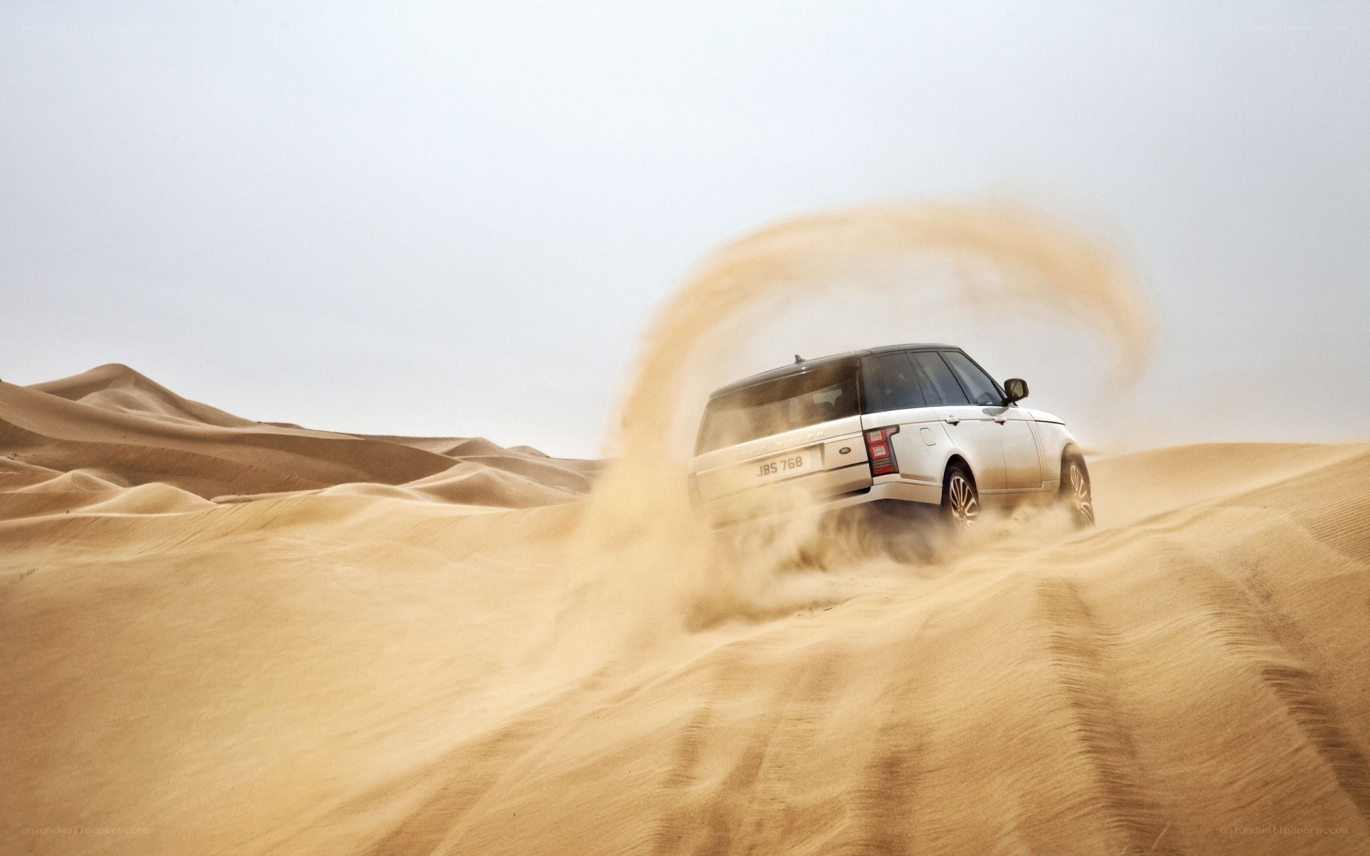 SUV driving on sand dunes