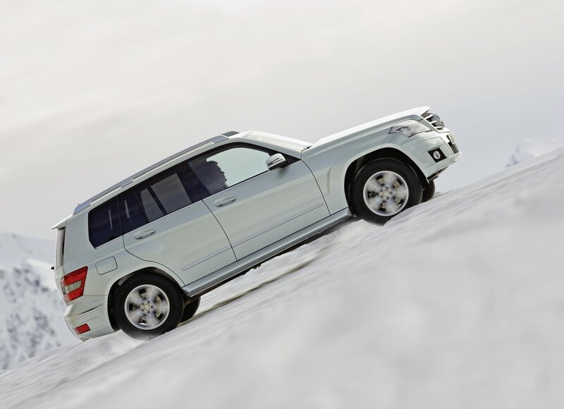 SUV driving on snowy hill