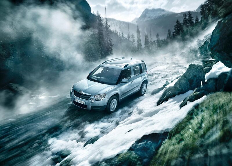 SUV driving on snowy mountain road