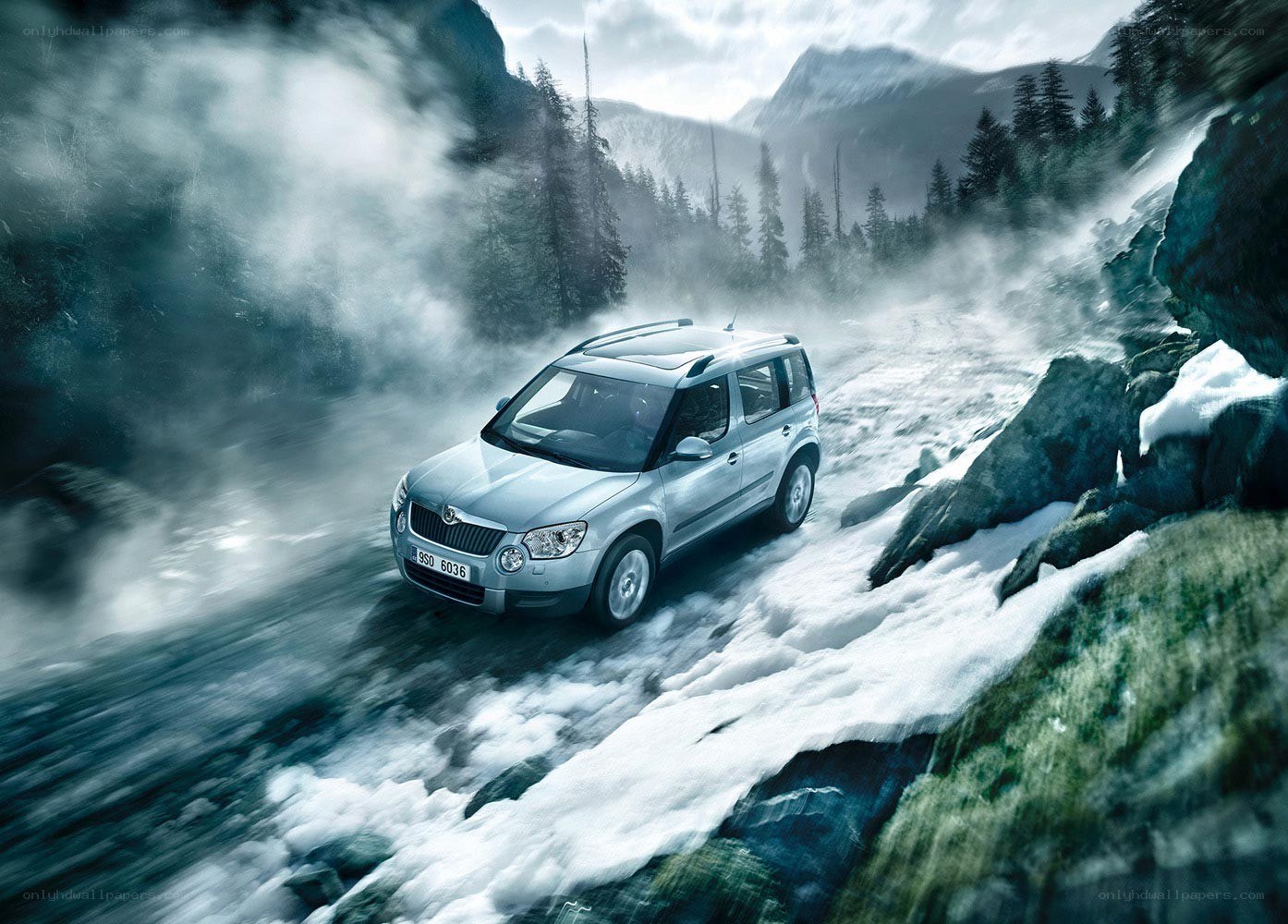SUV driving on snowy mountain road