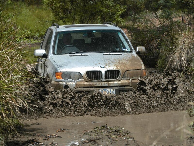 SUV driving through muddy water