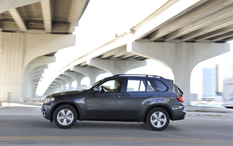 SUV driving under a bridge