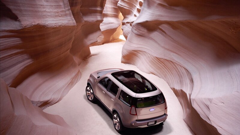 SUV in a sandstone canyon