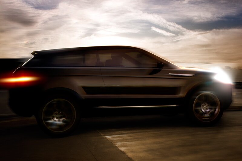SUV in motion at sunset