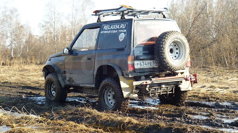 SUV in muddy field