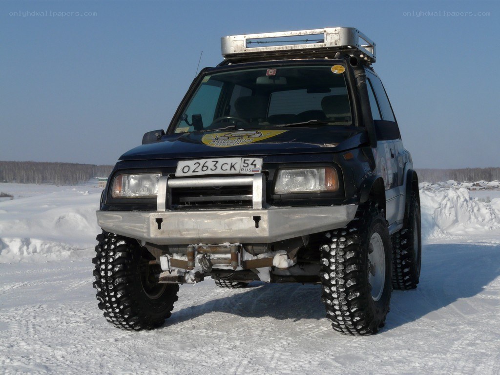 SUV in snowy landscape