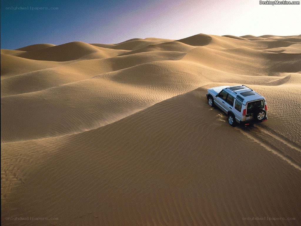SUV on desert dunes