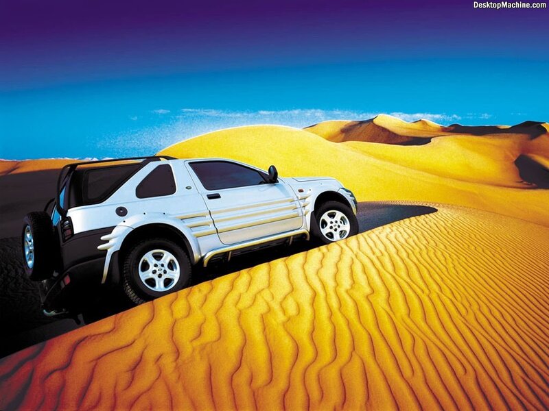 SUV on desert dunes