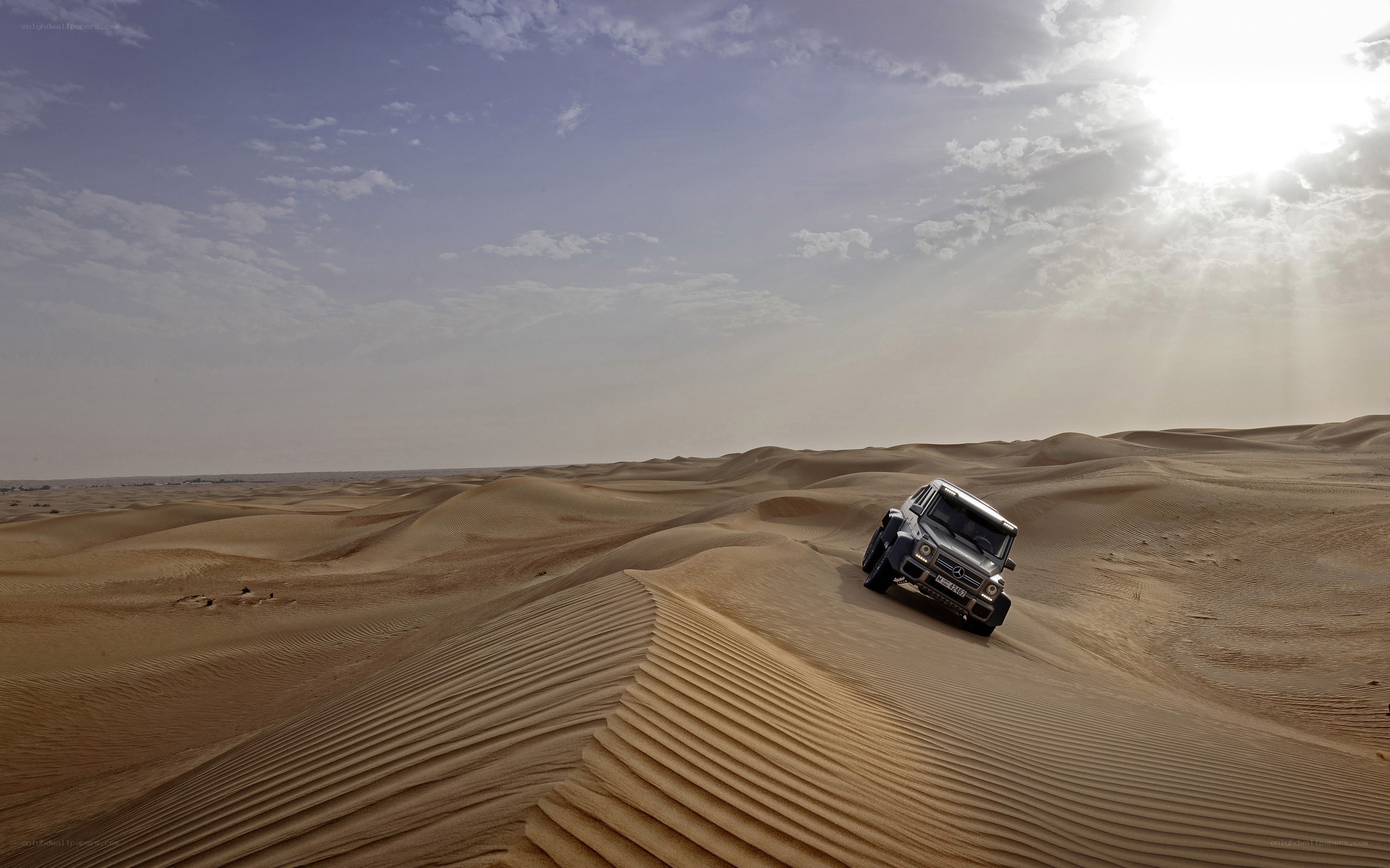 SUV on desert dunes