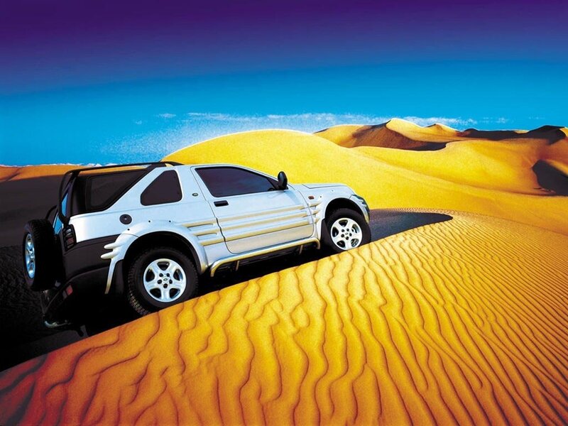 SUV on desert dunes
