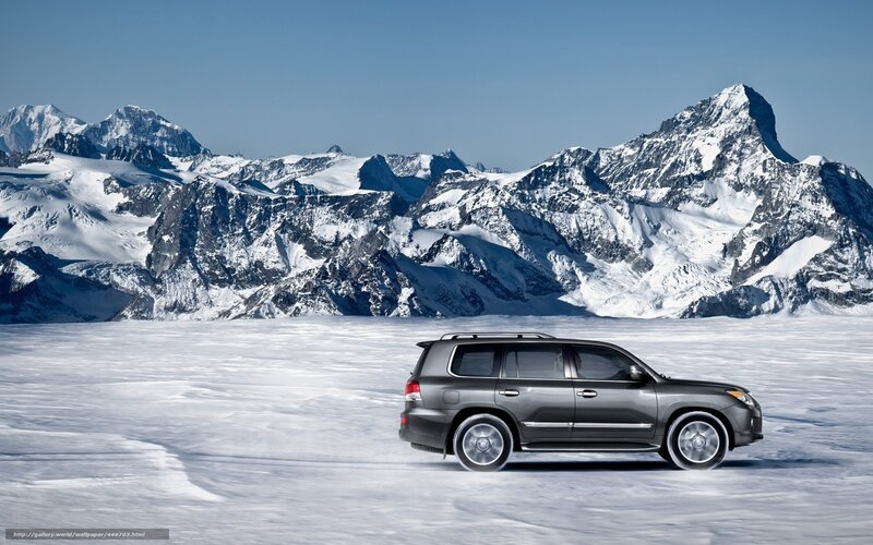 SUV on snowy mountain landscape