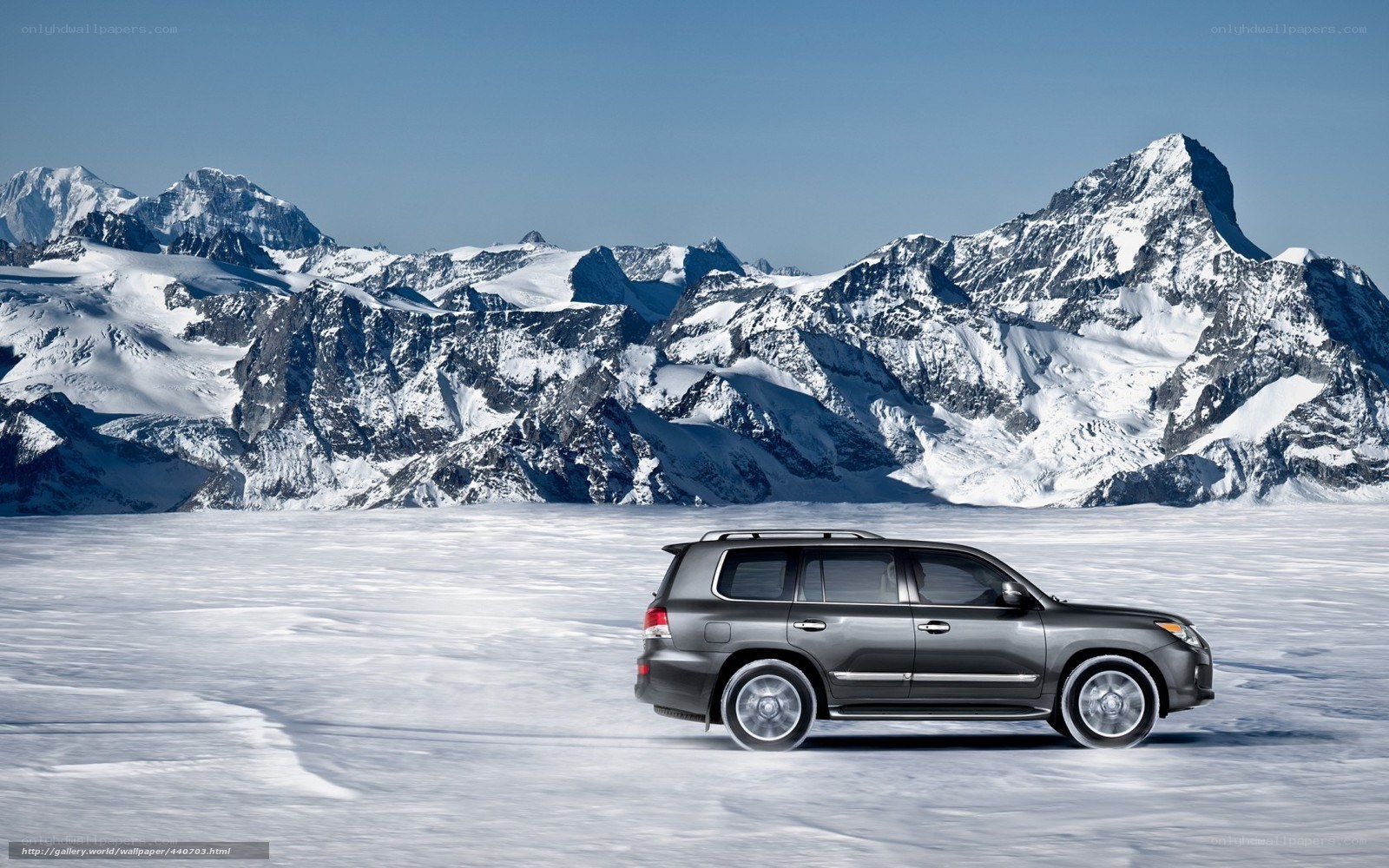 SUV on snowy mountain landscape