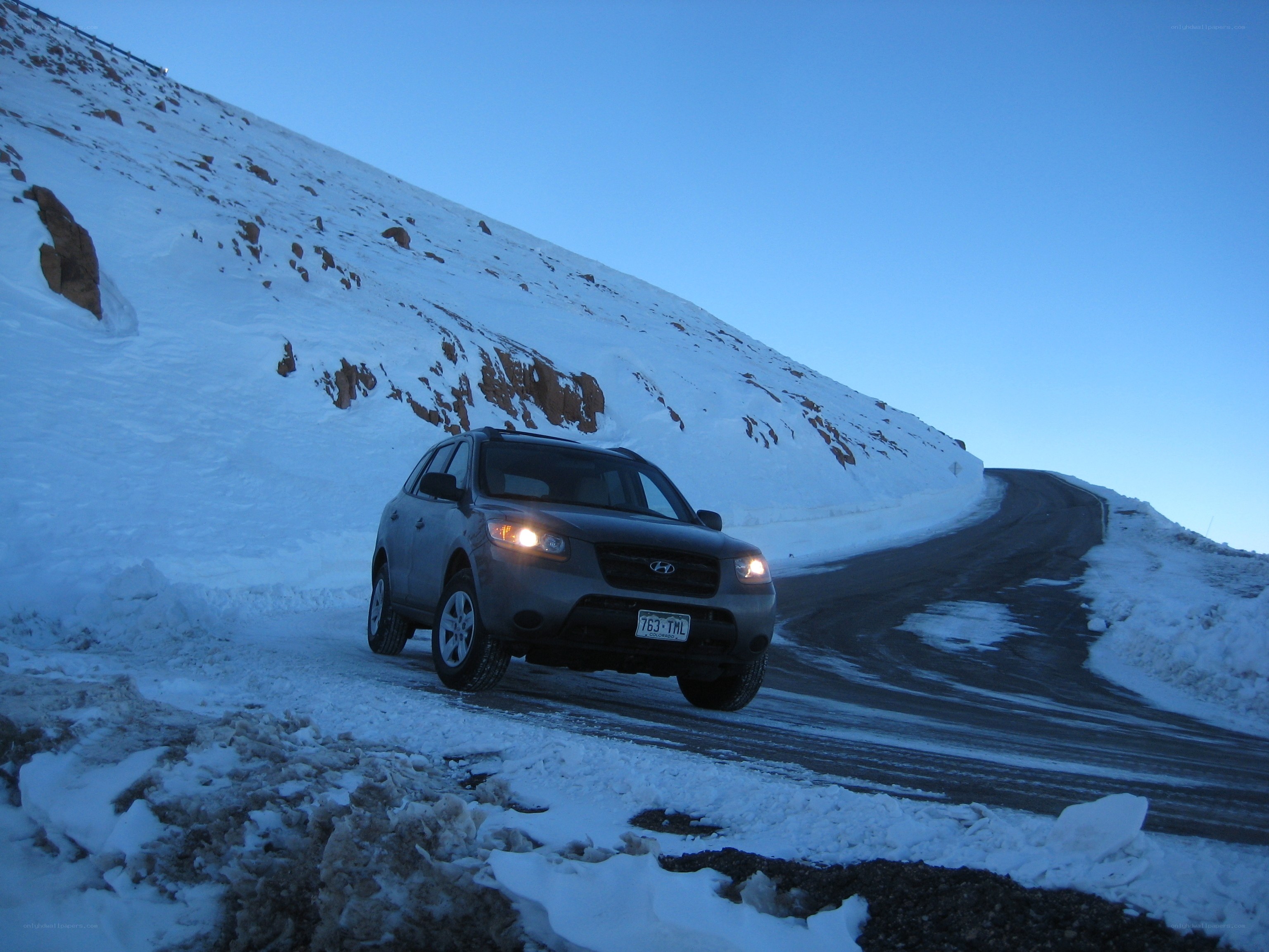 SUV on snowy mountain road