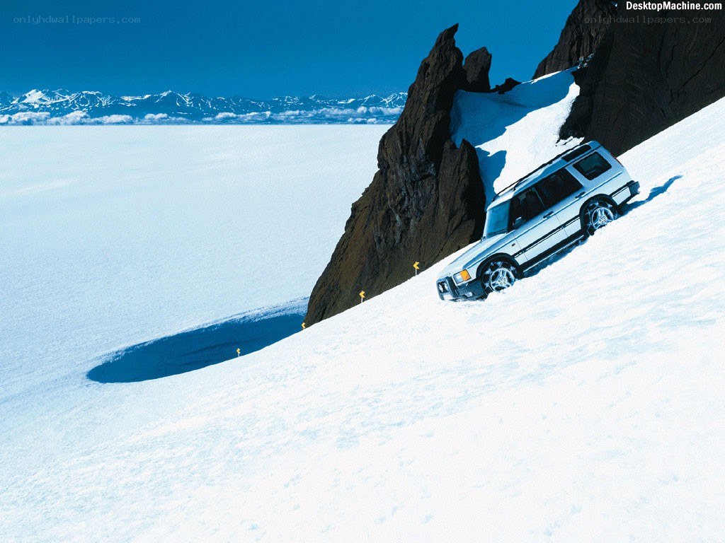 SUV on snowy mountain slope