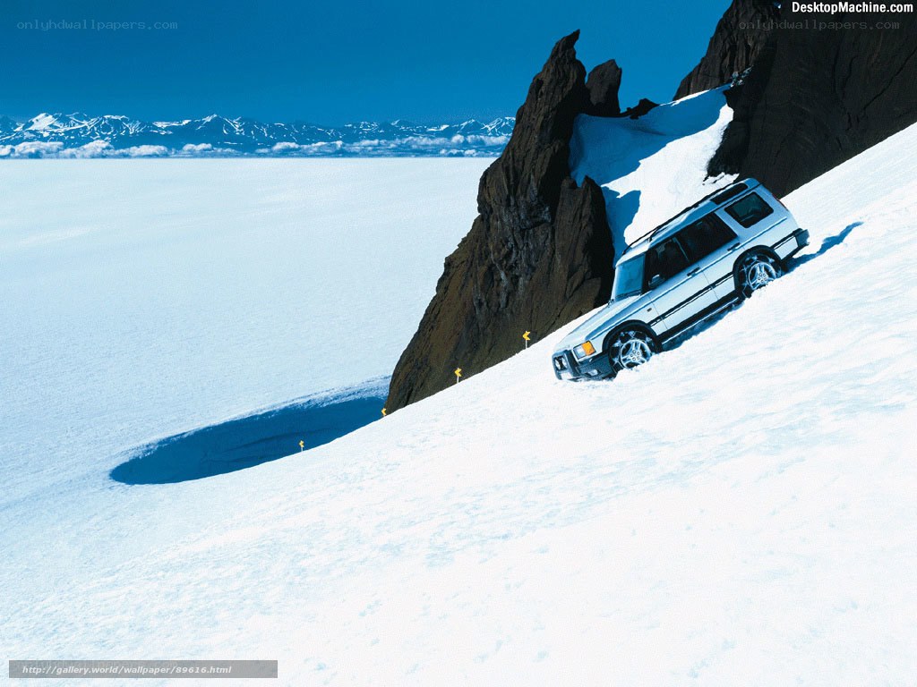 SUV on snowy mountain slope