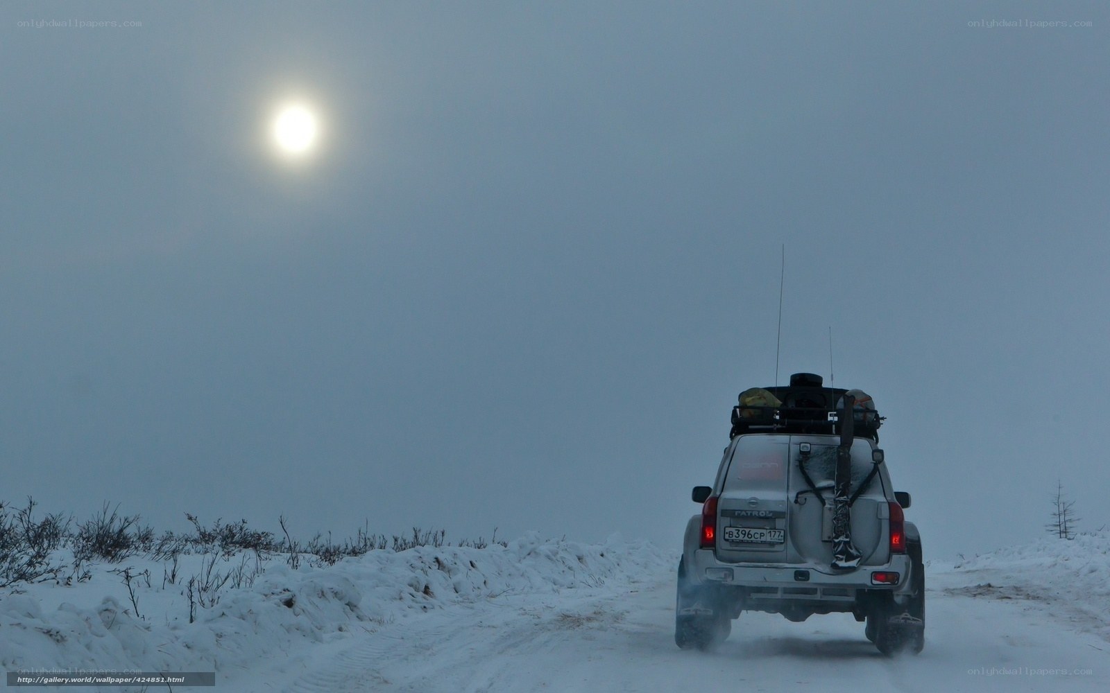 SUV on snowy road at night