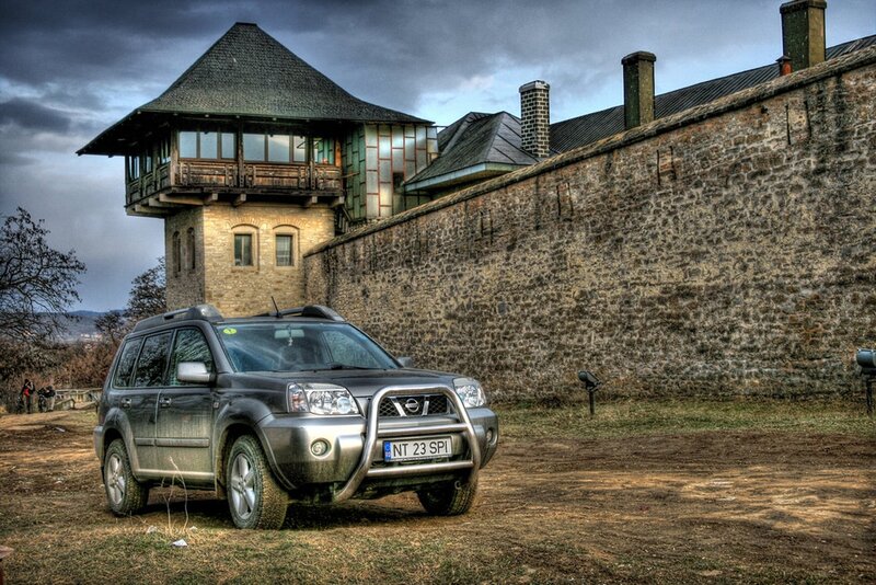 SUV parked near old fortress