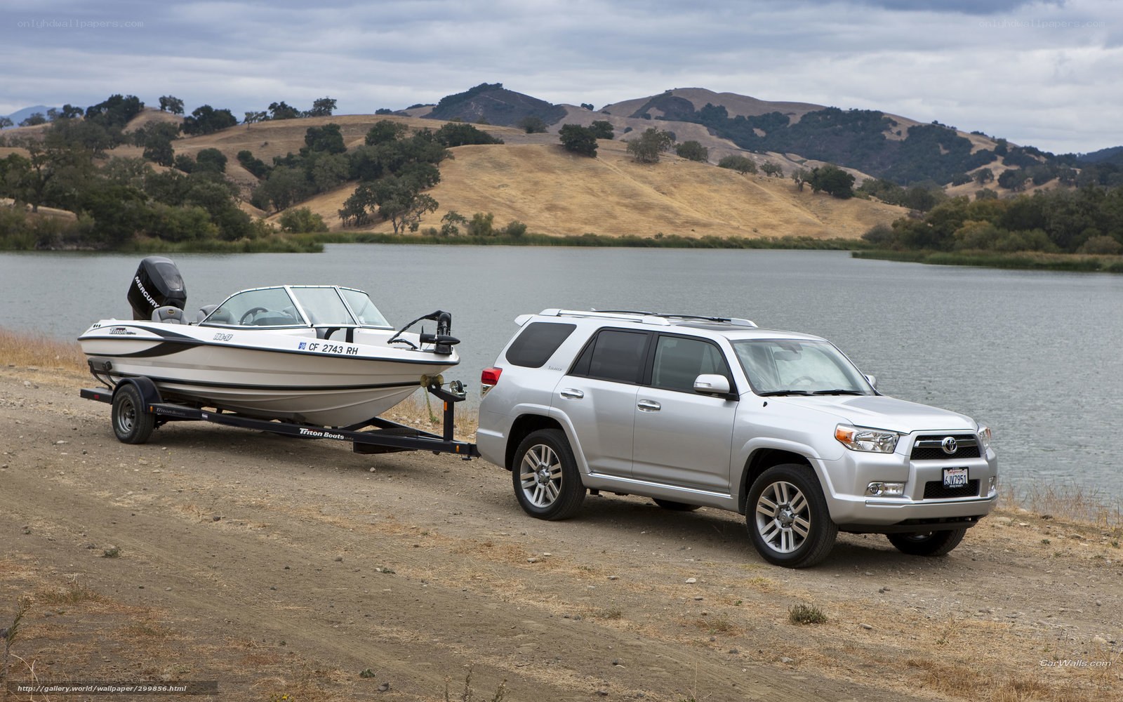 SUV towing boat at lake