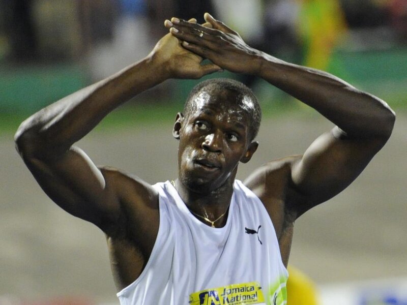 Sweating Athlete with Hands Raised