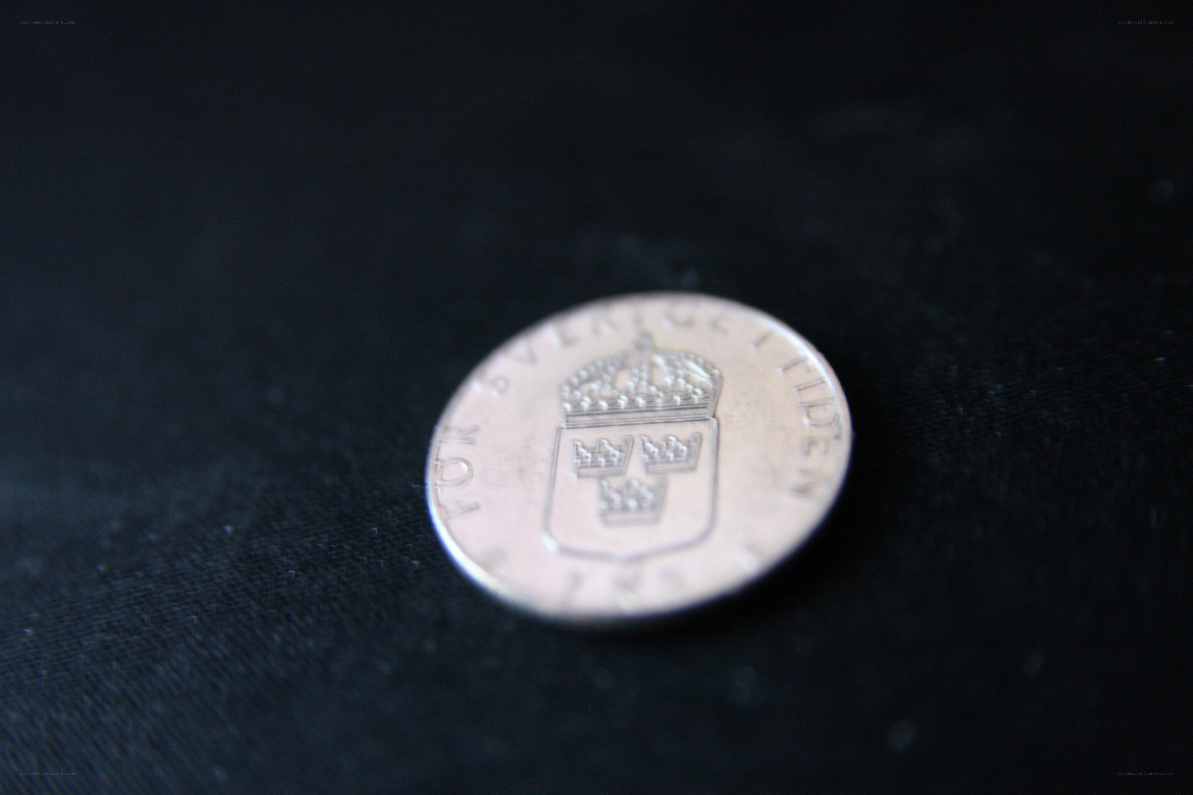 Swedish coin on black fabric