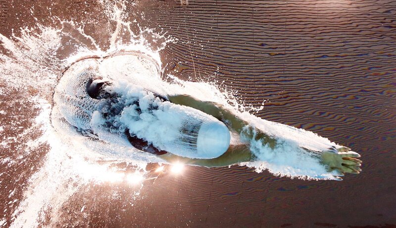 swimmer diving into water