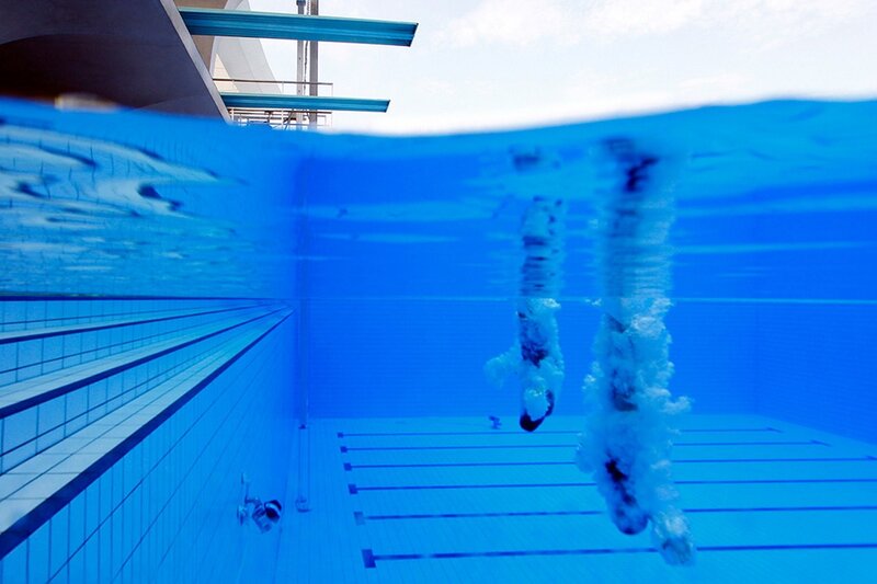 swimmers diving underwater