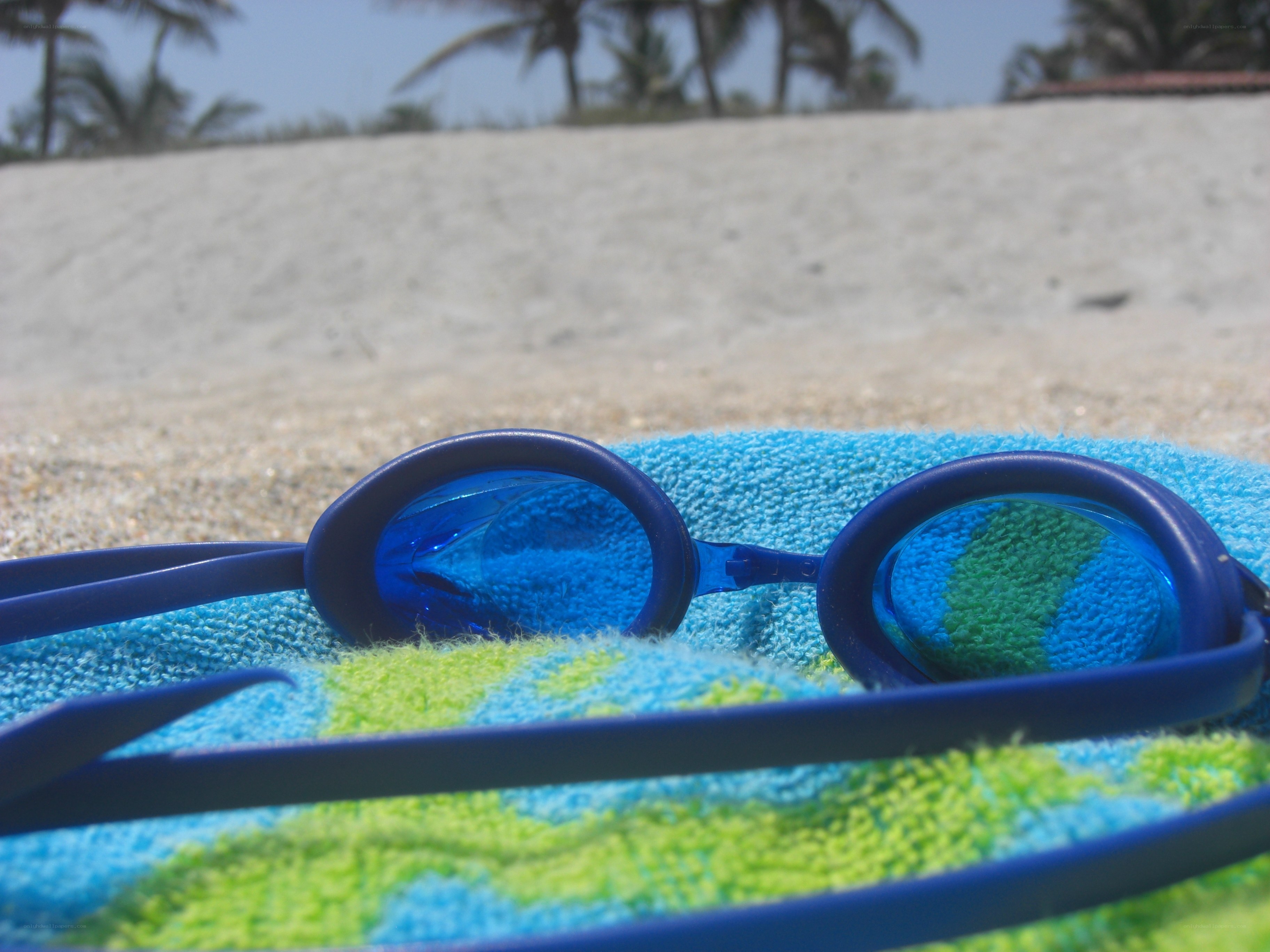 swimming goggles on beach towel