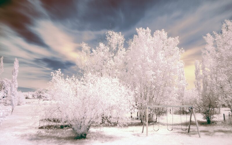 Swing Set in Snowy Field — White, Dramatic