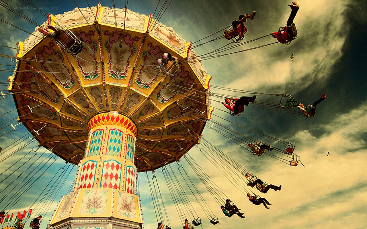 Swinging carnival ride at dusk