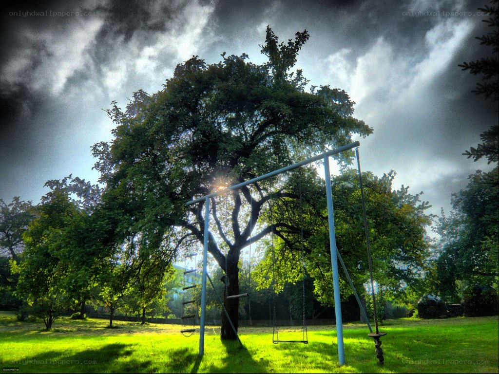 Swings under a stormy sky